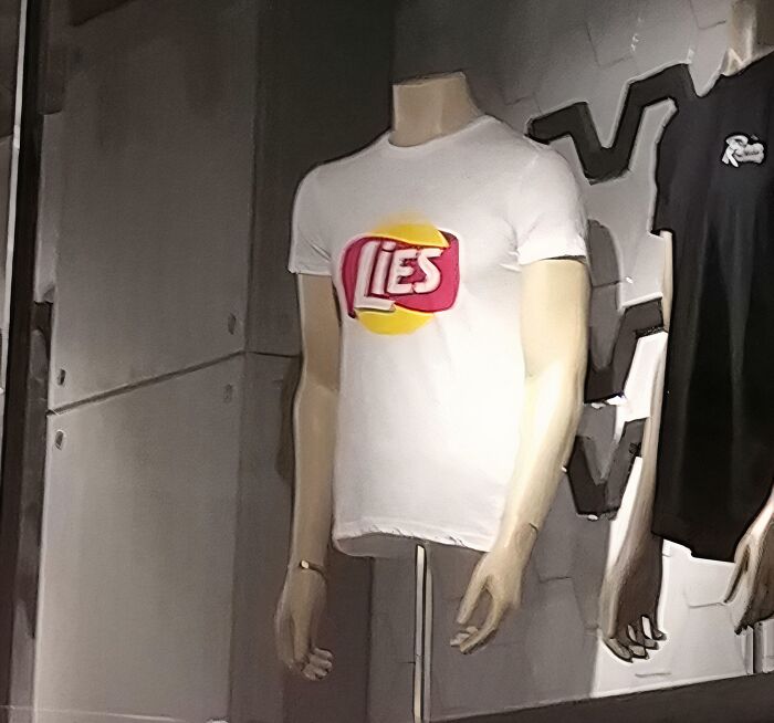Mannequin wearing a hilariously bad t-shirt design with the word lies, showcasing design that needed one more brain cell.