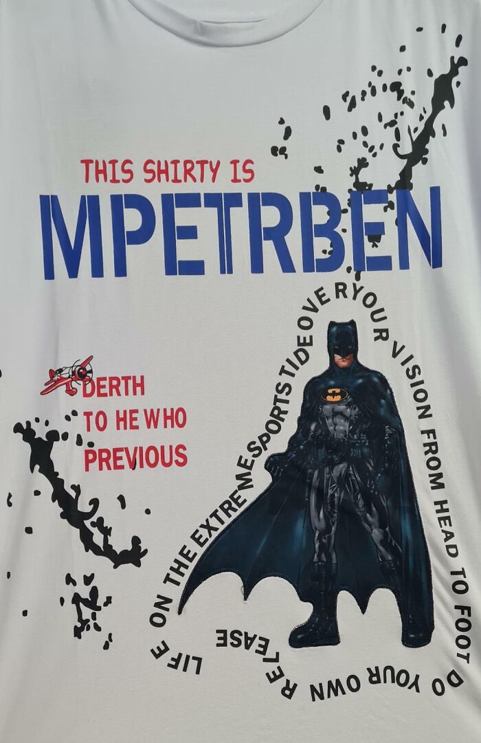 White shirt with a confusing Batman design and misspelled words, showcasing a hilariously bad T-shirt design.