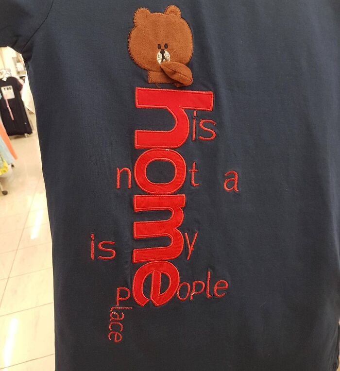 Black t-shirt with a hilariously bad design featuring a bear and jumbled text about home and people.