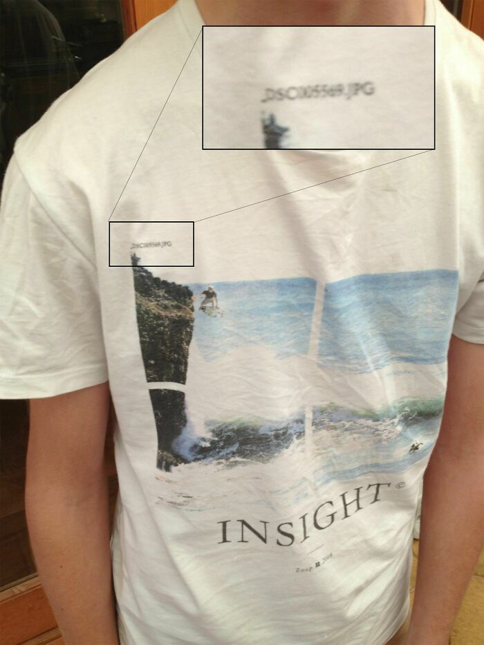 White t-shirt with a printed surfing design that includes a visible image file name, illustrating bad t-shirt designs.