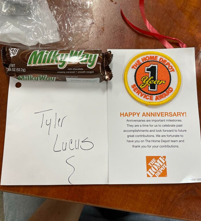 Home Depot one-year service award card with a Milky Way candy bar, highlighting workplace recognition and employee milestones.