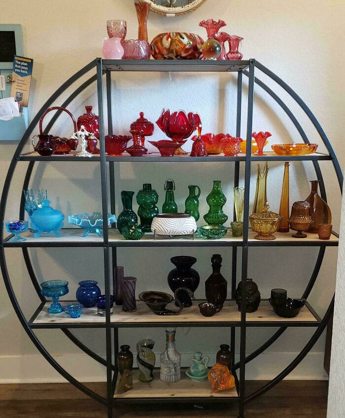 Various colorful and creative glass items displayed on a circular shelf, perfect unique glass decor for your home.