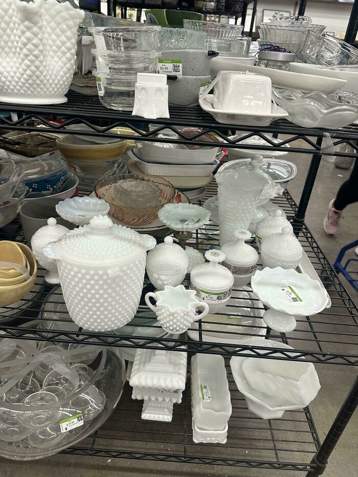 Assortment of cool and creative glass items on shelves including milk glass containers and decorative pieces for home decor.