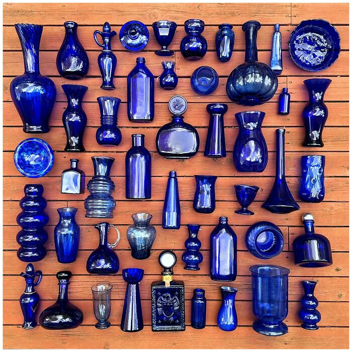 Collection of cool and creative blue glass items arranged on wooden surface for unique home decor inspiration