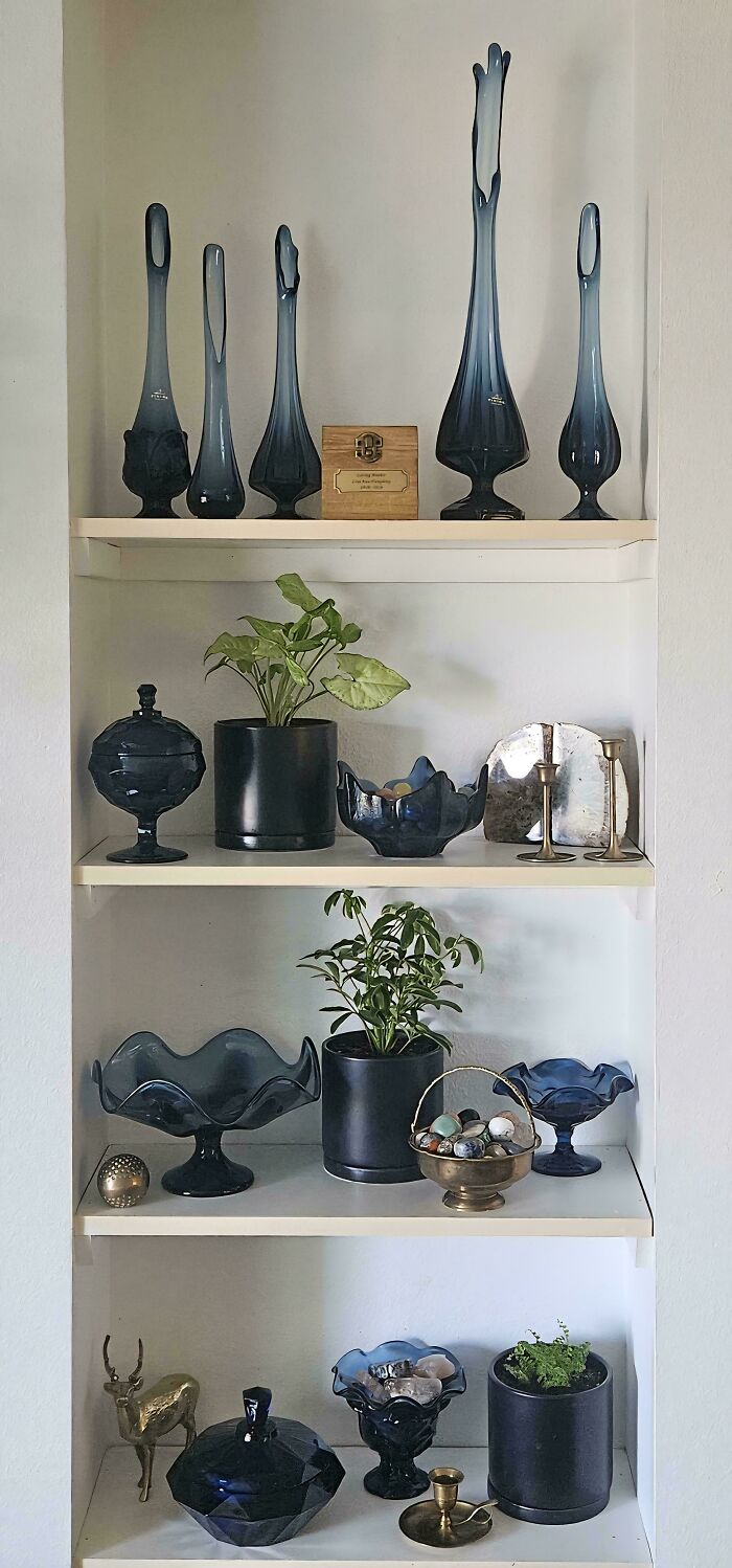 Shelf display of cool and creative glass items including vases, bowls, and decorative pieces in a home setting.