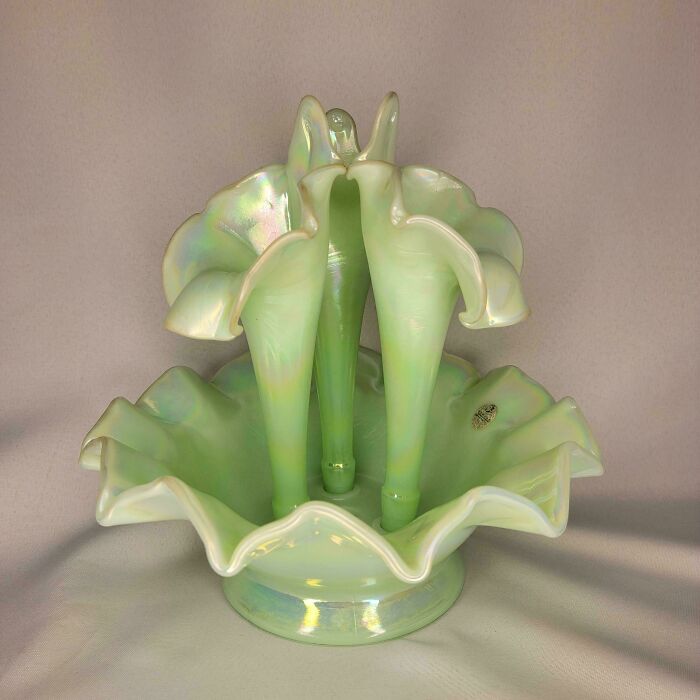 Iridescent green decorative glass item with floral-inspired design, a cool and creative glass piece for the home.