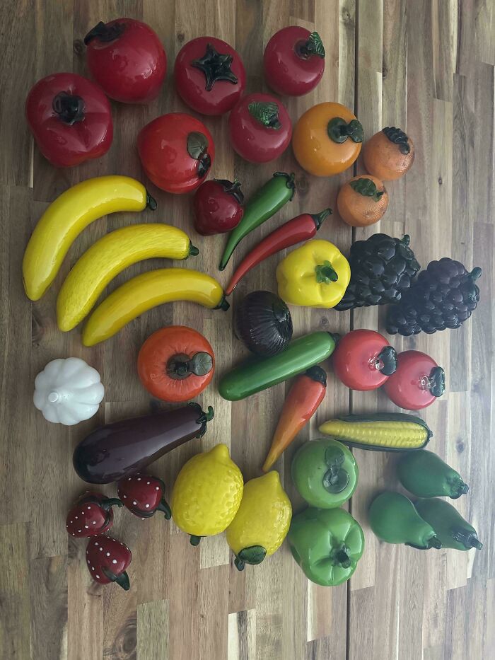 Colorful and creative glass fruit and vegetable items arranged on a wooden surface for home decor inspiration