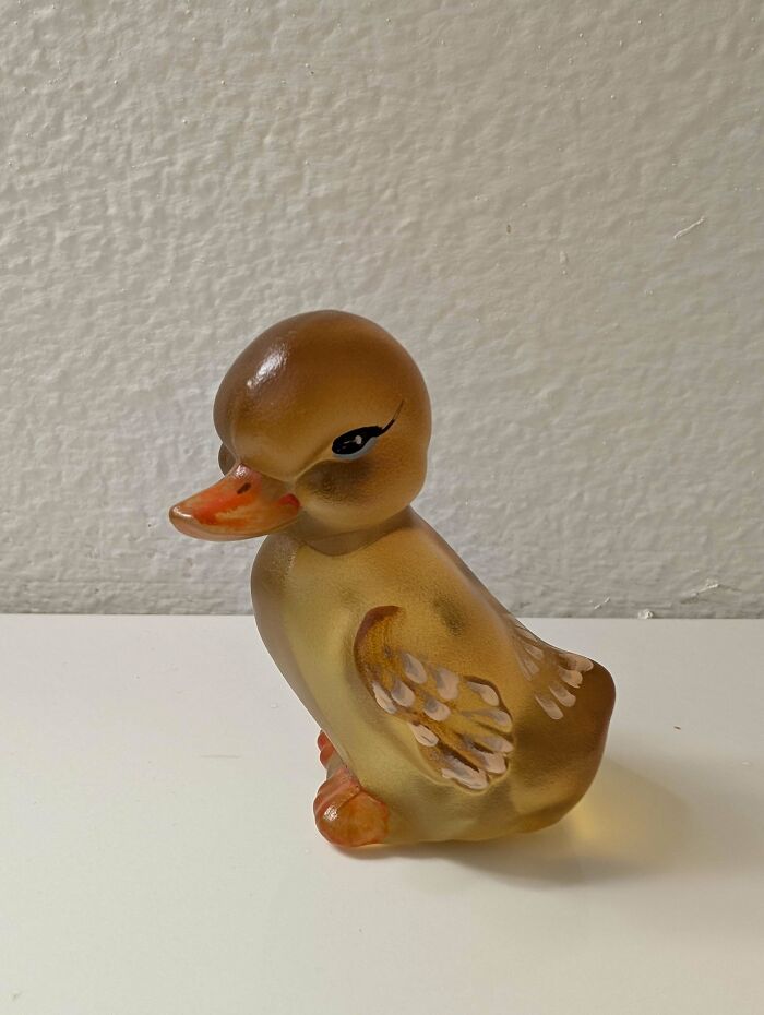 Glass duck figurine with detailed wings and an orange beak, a creative glass item perfect for home decor.
