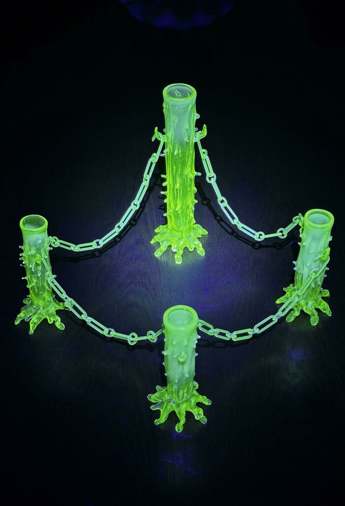 Glowing green creative glass item with intricate spiked design linked by chain, perfect unique glass decor for home.