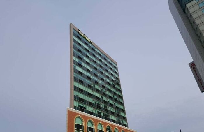 Tall building with distorted perspective appearing to lean sharply, an unedited photo that might mess with your brain.