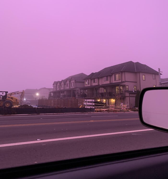 View of a residential construction site at dusk under a striking purple sky, an unedited photo that might mess with your brain.