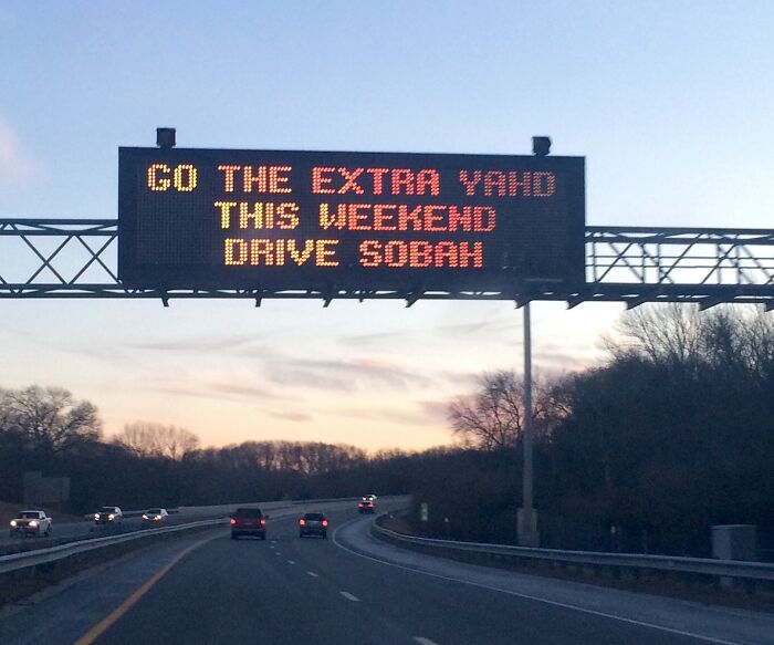 Highway digital sign encouraging drivers to go the extra yard this weekend, capturing the essence of US states travel.