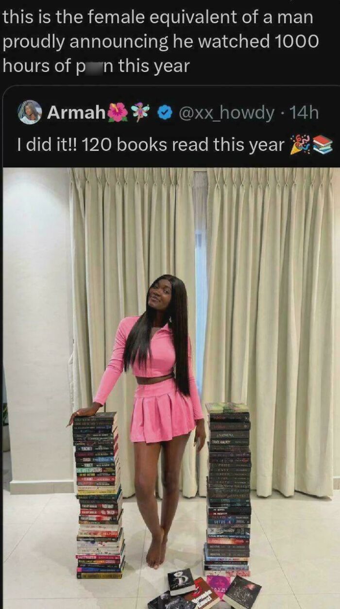 Woman in pink outfit posing with stacks of books, highlighting a contrast in toxic men that made women sick.