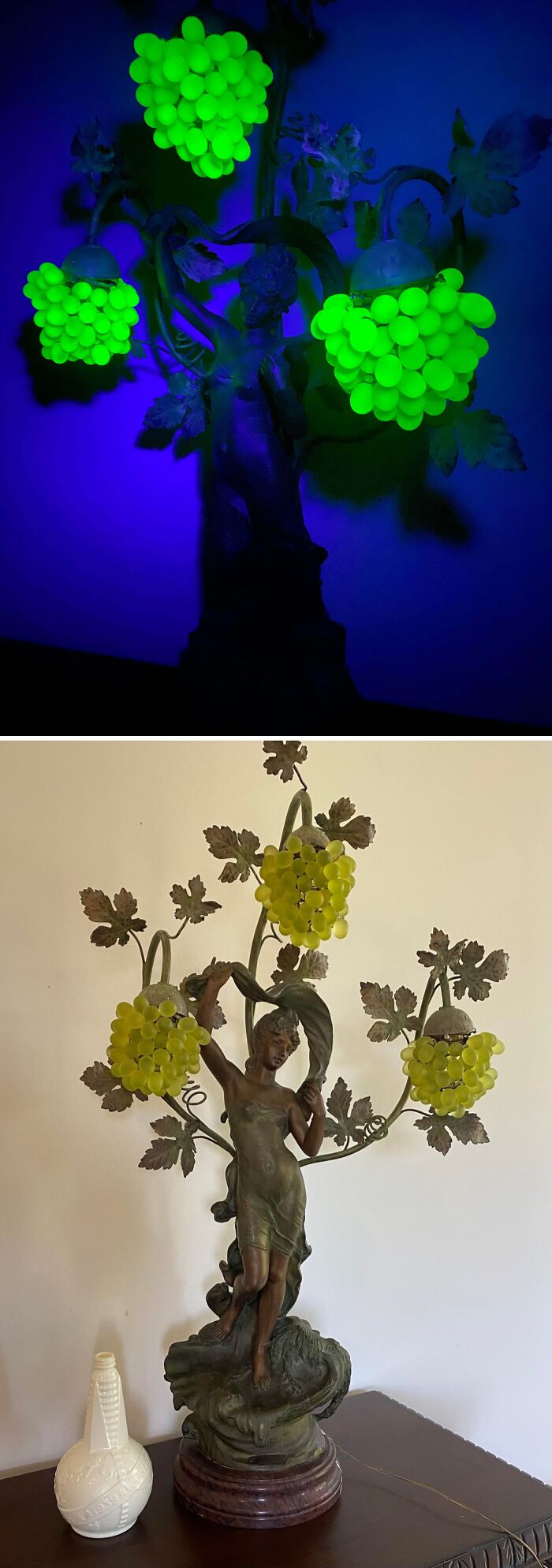 Vintage glass lamp with grape cluster designs glowing green in dark and bronze sculpture base in daylight.
