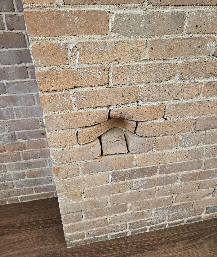 Uneven brick wall with an oddly positioned brick that looks like it might mess with your tired brain.