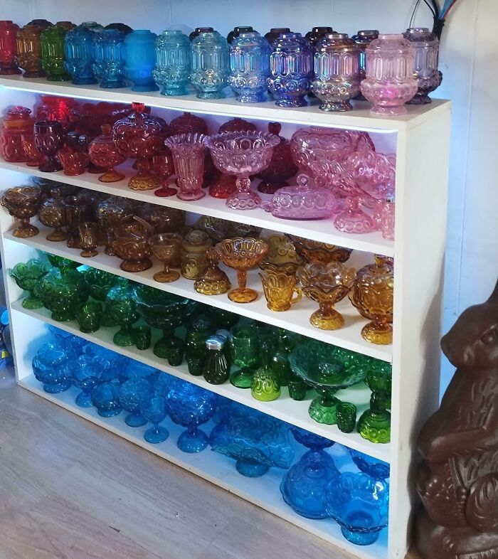 Colorful and creative glass items displayed on shelves, showcasing unique glass pieces perfect for home decor.