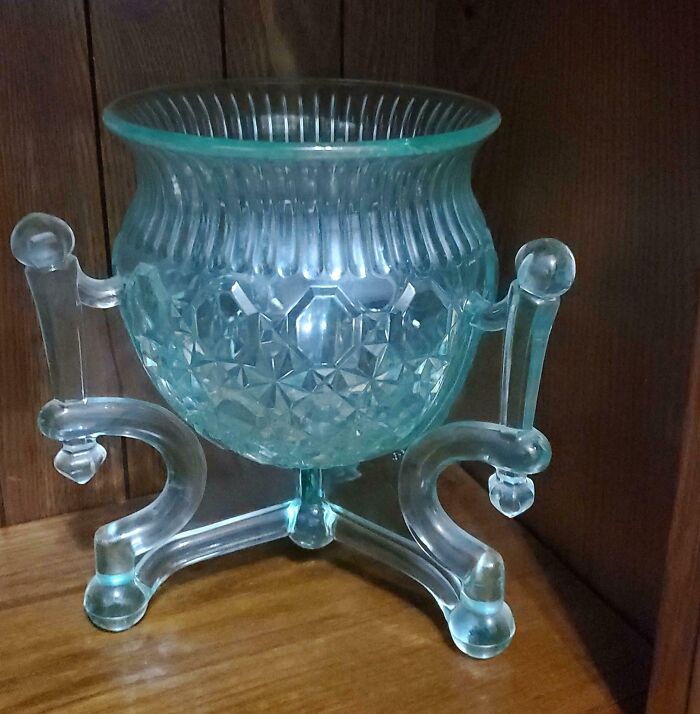 Decorative vintage glass item with intricate patterns and unique stand, a cool and creative glass piece for home décor.
