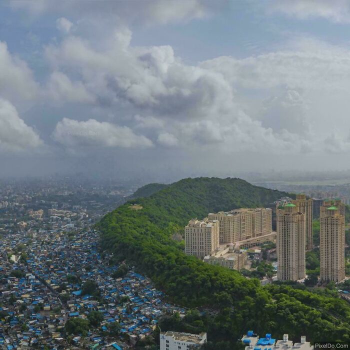Contrast between dense slum and high-rise buildings in urban hell cityscape