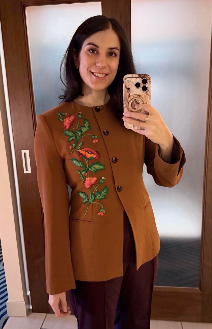 Woman in a brown blazer featuring stunning floral embroidery creations, inspiring new hobby.