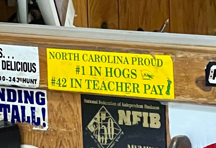 Yellow sign with humorous text about North Carolina, capturing the essence of state pride in US pictures collection.