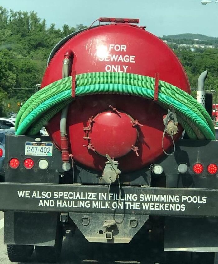 Red sewage truck with green hoses and a humorous message, captured in a unique picture representing the essence of each US state.