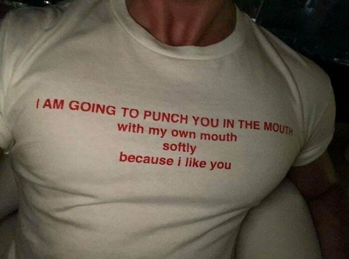 Close-up of a person wearing a shirt with humorous text illustrating seemingly innocent posts with a crazy second half.