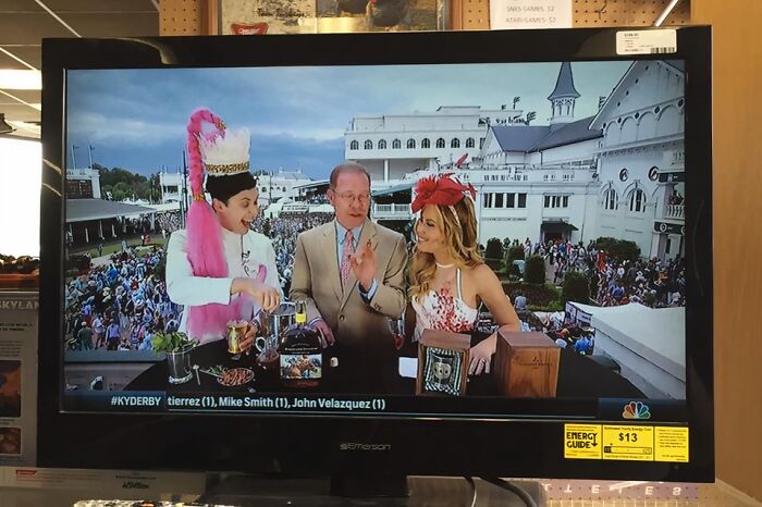 Television screen showing Kentucky Derby coverage with hosts dressed festively, capturing the essence of each US state event.