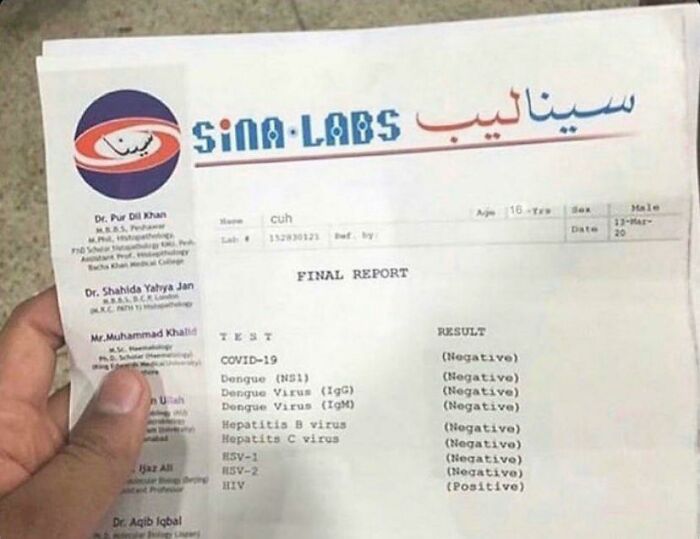 Hand holding a medical lab report showing multiple negative virus test results with one positive HIV result.