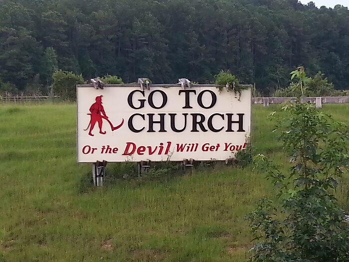 Roadside sign with a religious message in a rural setting, capturing the essence of faith in the US countryside.