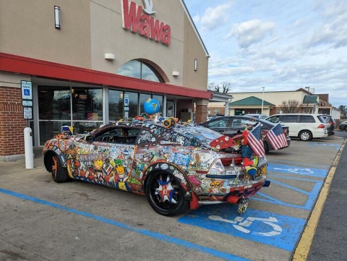 Colorfully decorated car with American flags parked outside a Wawa store, capturing the essence of each state in the US.