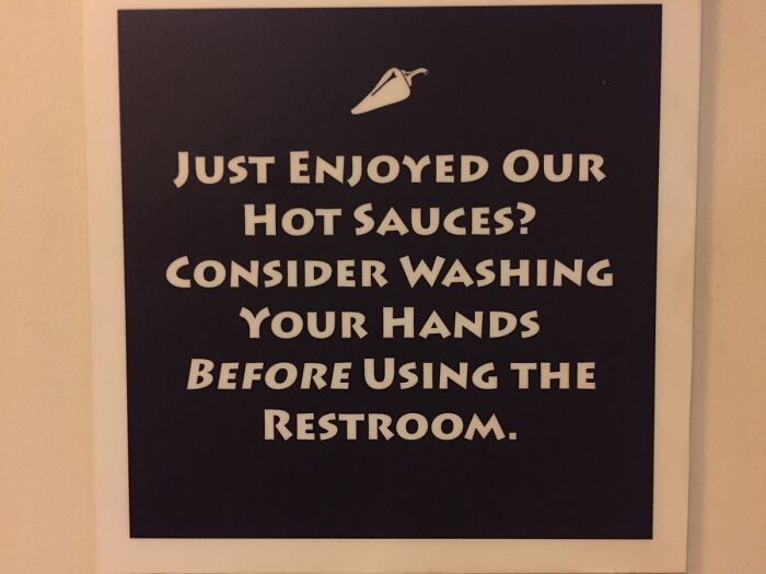 Funny pieces of advice sign about washing hands after enjoying hot sauces, highlighting humor in daily tips.