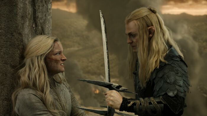 Two characters with long blonde hair in a tense scene from Stephen Colbert’s new Lord of the Rings movie timeline. Two characters with long blonde hair in a tense scene from Stephen Colbert’s new Lord of the Rings movie timeline.