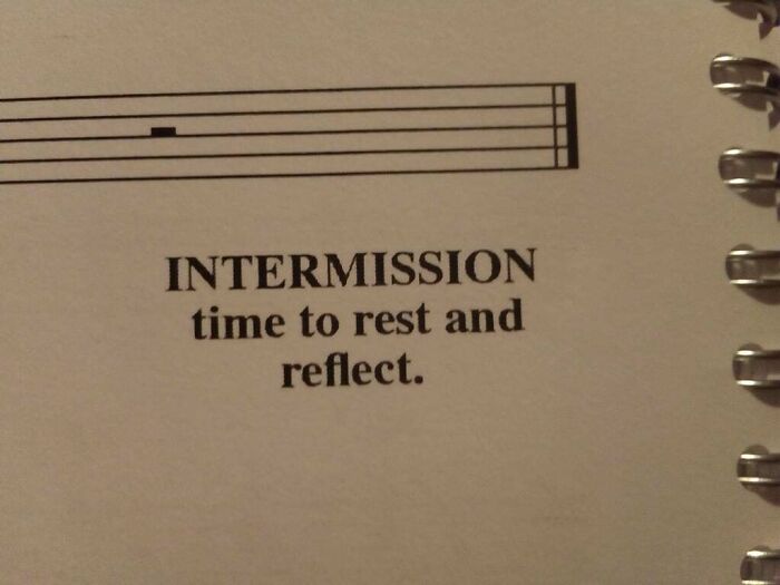 Close-up of a notebook page with funny advice text saying intermission time to rest and reflect, part of humorous pieces of advice.