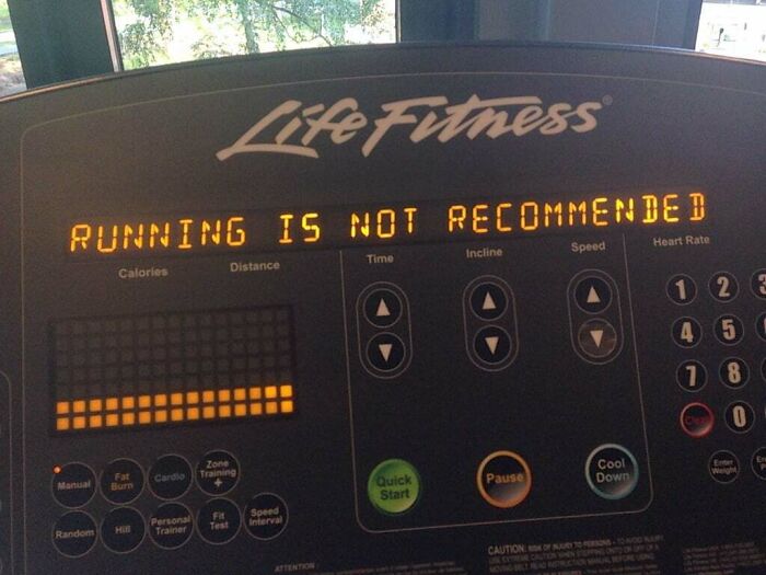 Treadmill display showing a warning message about running, related to funny pieces of advice for fitness humor.