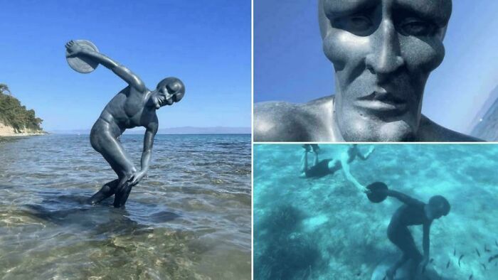 Interesting vault showing a bizarre underwater statue of a man poised to throw a discus in clear shallow water near shore.