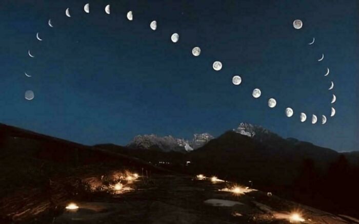 Phases of the moon forming a heart shape over mountains at night in an interesting vault of nature oddities.