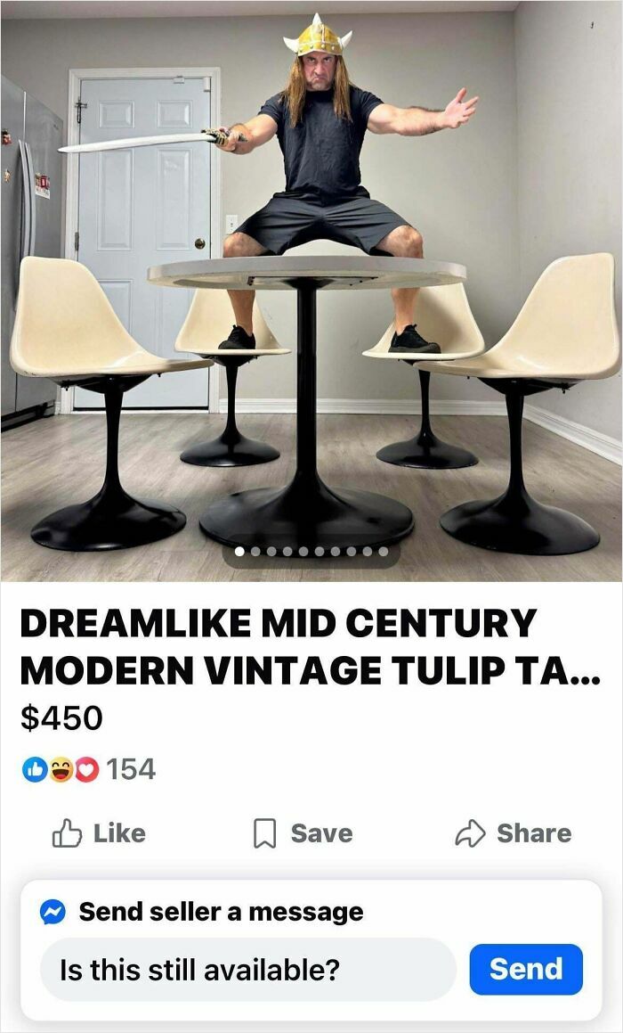 Man wearing a Viking hat and holding a sword stands on a mid century modern vintage tulip table for sale online.