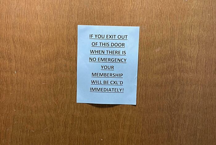 Gym warning sign threatening immediate membership cancellation if door is exited without emergency, a gym Darwin Award contender moment.