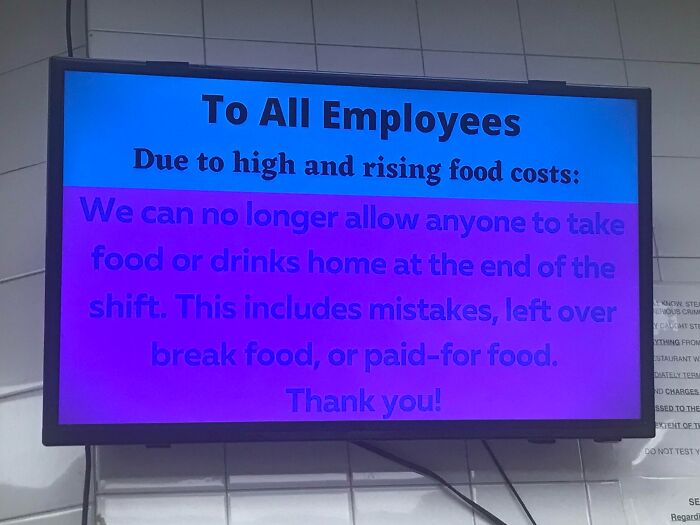 Workplace photo showing a sign about food policy changes due to rising costs, highlighting challenges at work.