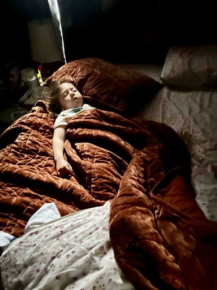 A sleeping child lit by a single light source, capturing an Accidental Renaissance mood.