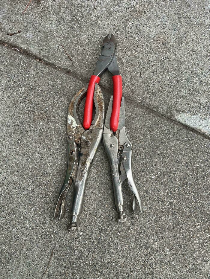 A pair of pliers holding vice grips upright in a clever solution for random junk.