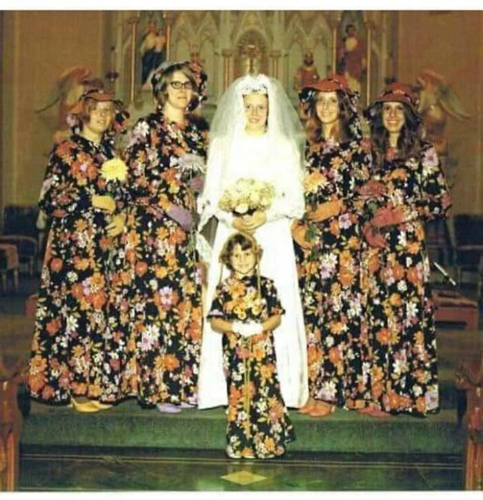 A candid old photo shows a bride, bridesmaids, and a flower girl in matching floral dresses, revealing what the world looked like generations ago.