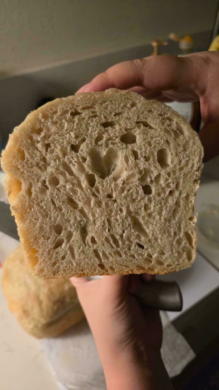 Freshly baked bread slice showing soft texture and holes inside