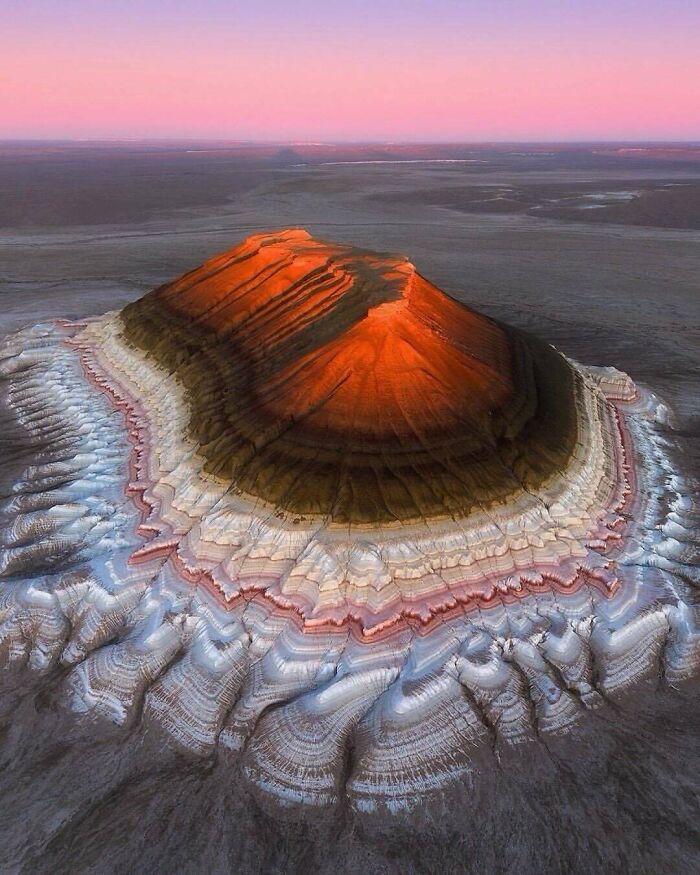 Uplifting posts: A vibrant, colorful mountain at sunset, showcasing interesting geological formations.
