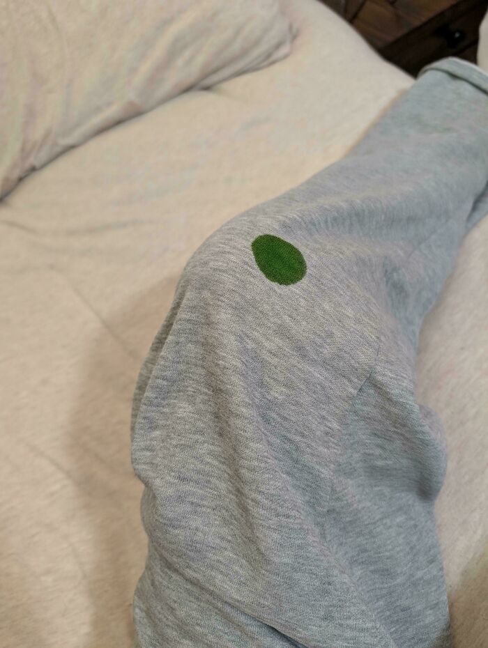 Green spot on grey fabric creating a creepy and weird visual effect, perfect for spooky and heebie-jeebies photo collections.