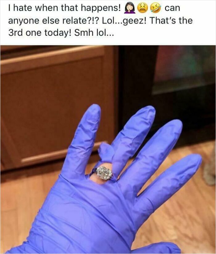 Hand wearing a blue glove with an engagement ring stuck on the glove, illustrating a cringeworthy moment.
