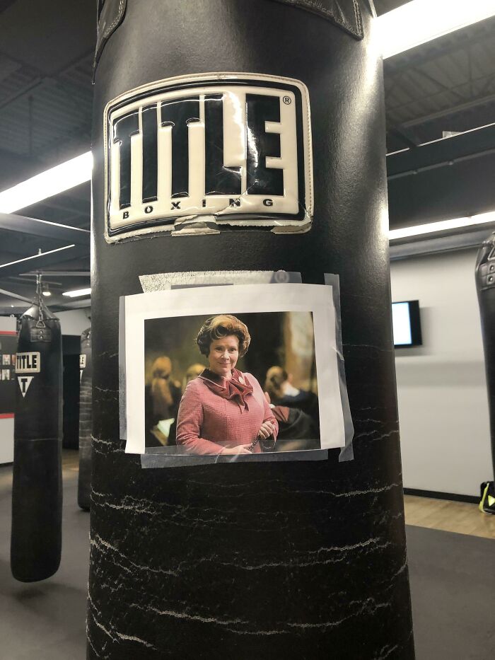 Boxing punching bag in a gym with a taped photo of a woman, a quirky sight gym visitors couldn't believe their eyes.