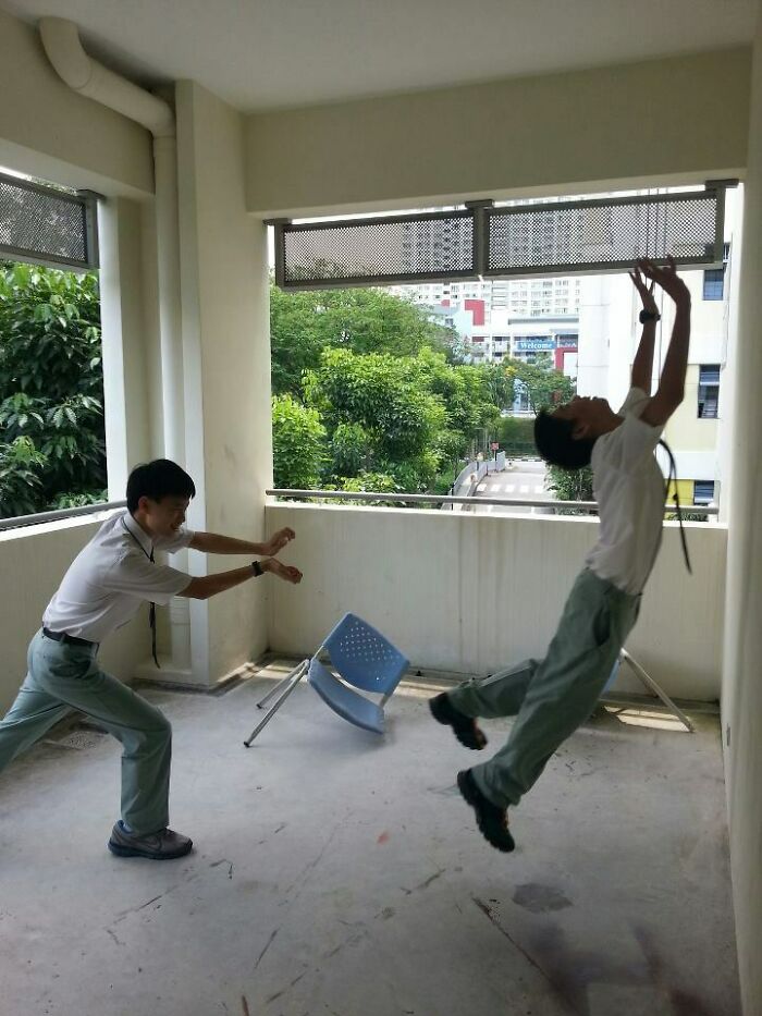 Two young men in creative poses, one appearing to push the other who is mid-air, showcasing hilarious and creative poses.