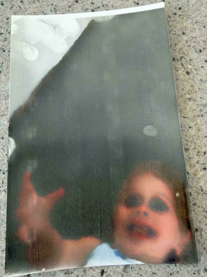 Blurry creepy photo of a child with distorted face and reaching hand, evoking creepy and weird feelings.