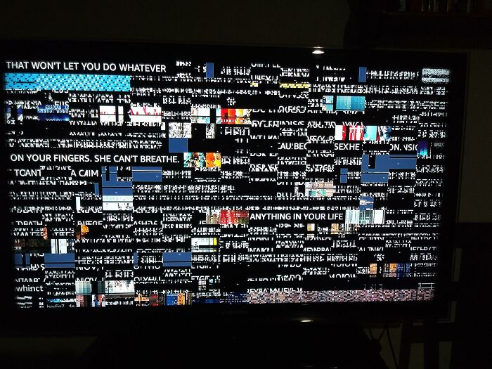 Distorted digital screen showing scrambled text and images, evoking unsettling mysteries and eerie visual disturbances.